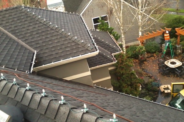 Christmas light take downs with a ladder and festive decorations, showcasing the post-holiday disassembly process.