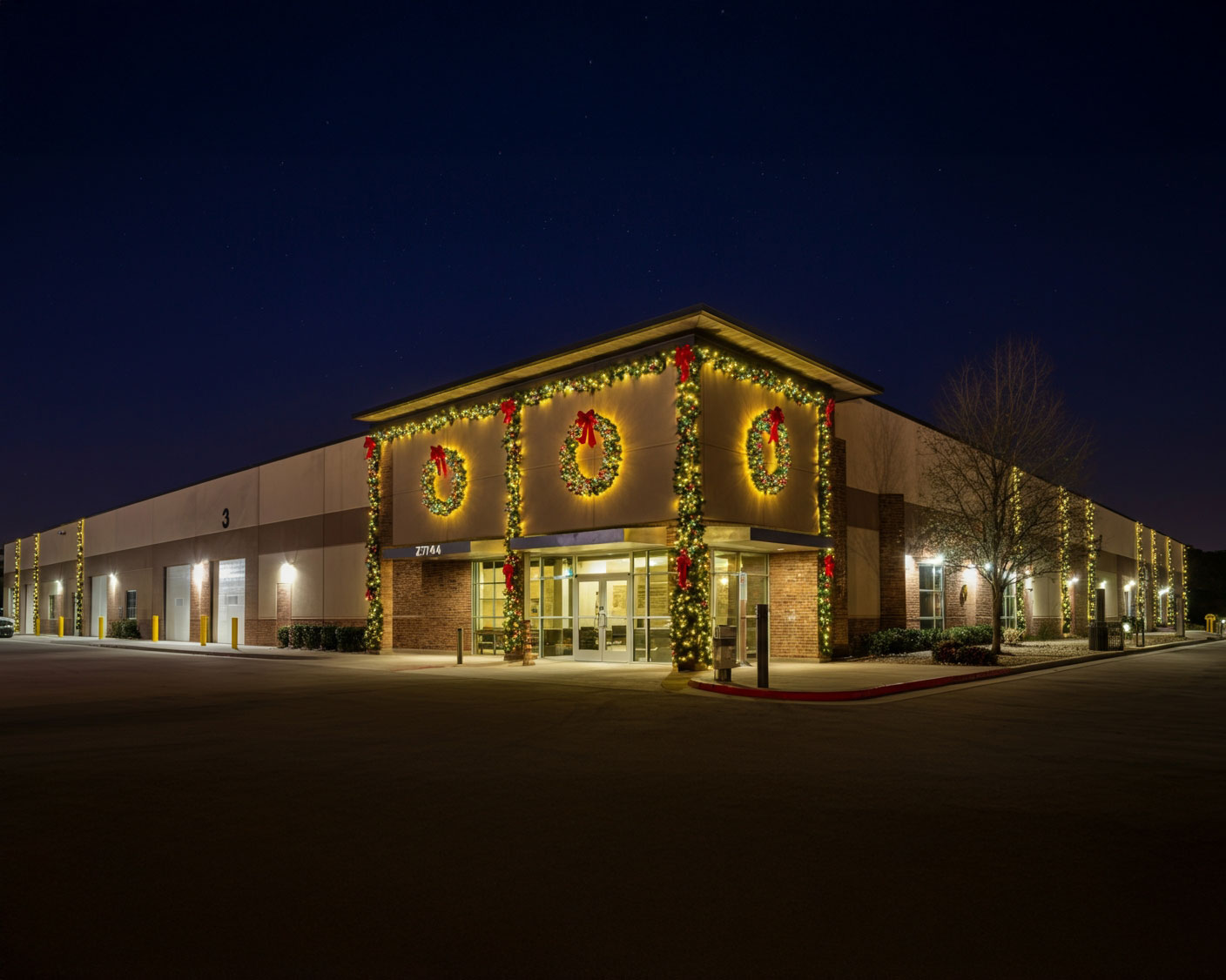 Industrial building adorned with colorful Christmas light decorations, creating a festive atmosphere during the holiday season.