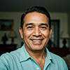 Professional headshot of Juan Vargas Senior, smiling in business attire
